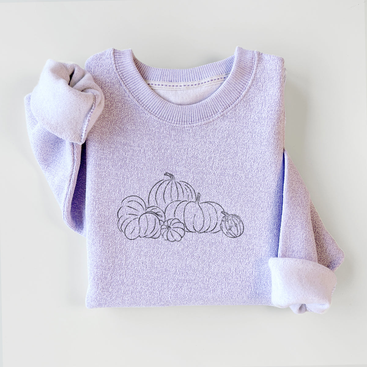 Ice purple knit sweatshirt printed with a black ink line drawing of a pile of pumpkins, styled flat.