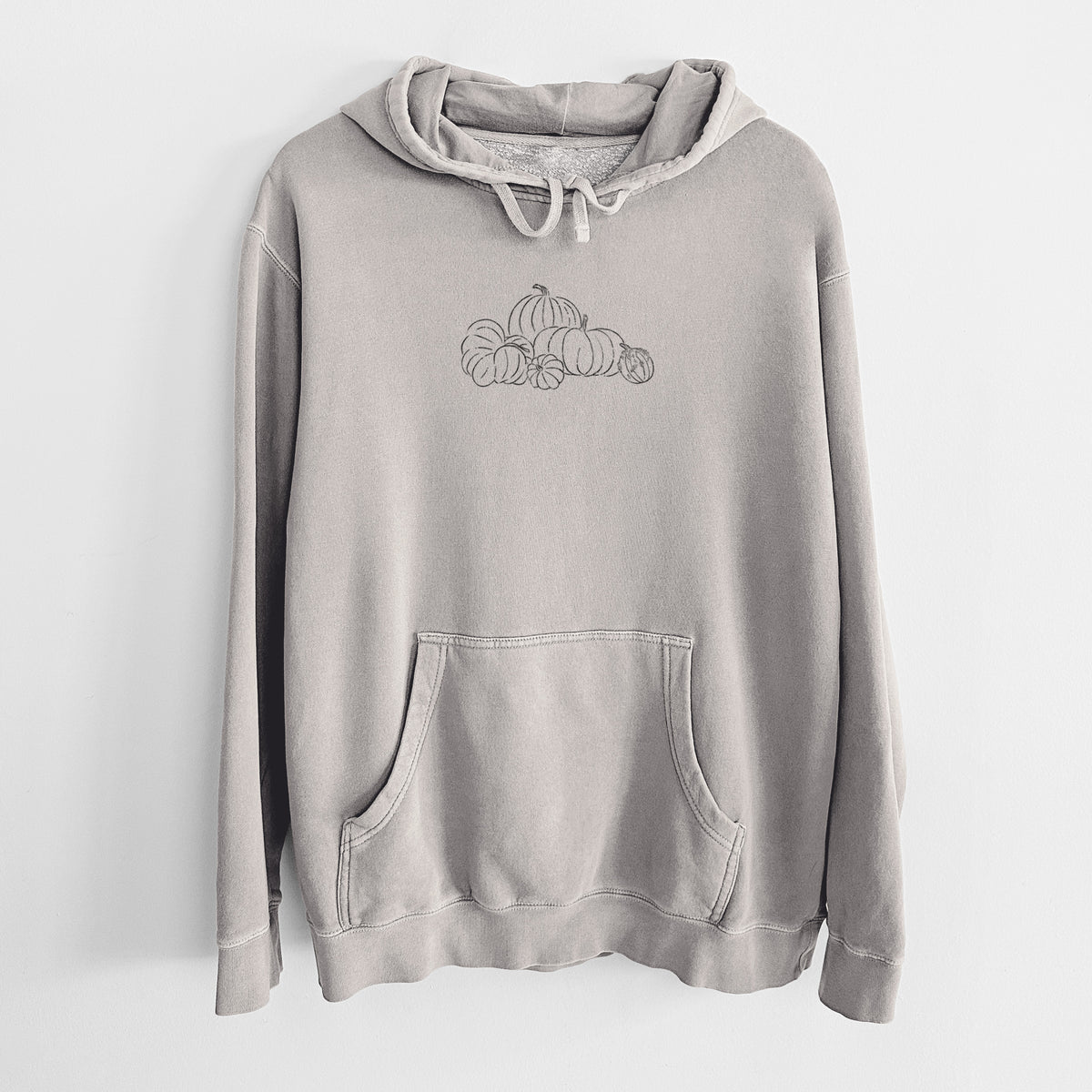 Cement grey pigment dyed hoodie laid flat, printed with a black ink line drawing of a pile of pumpkins.