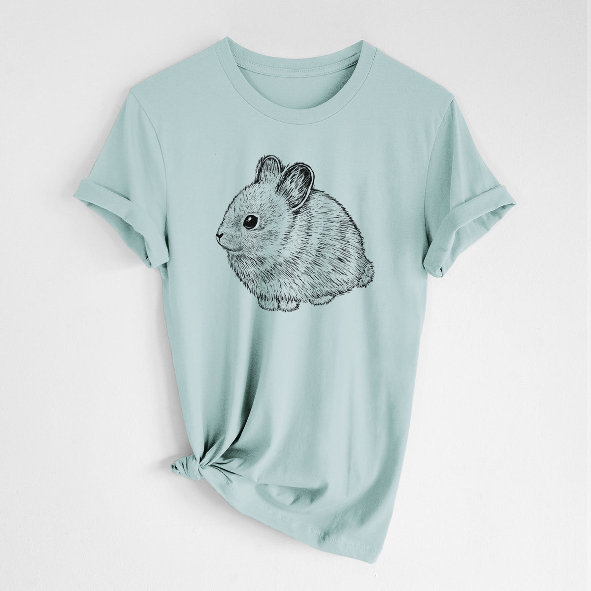 Dusty blue lightweight cotton t-shirt laid flat with the sleeves rolled, printed with a detailed black ink illustration of a round, fluffy pygmy rabbit.