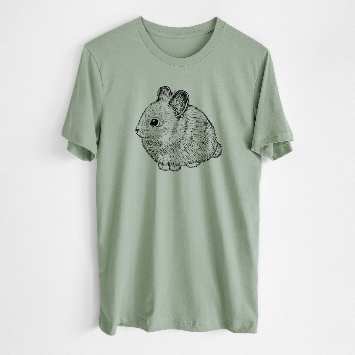Sage green lightweight cotton t-shirt laid flat, printed with a detailed black ink illustration of a round, fluffy pygmy rabbit.
