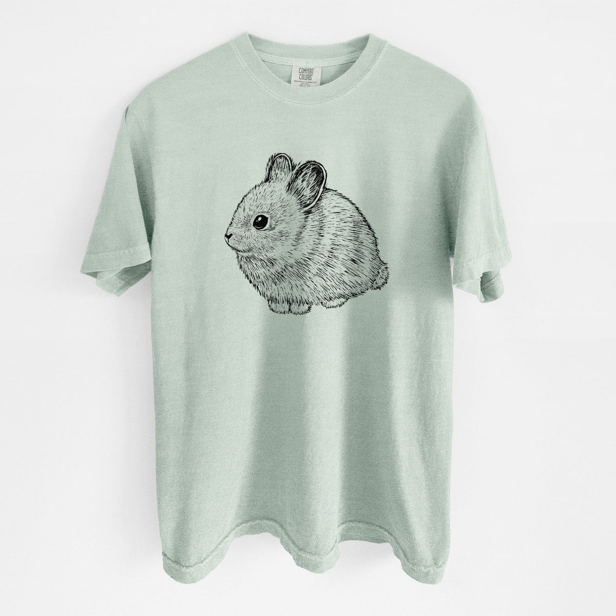 Bay green Comfort Colors t-shirt laid flat, printed with a detailed black ink illustration of a round, fluffy pygmy rabbit.