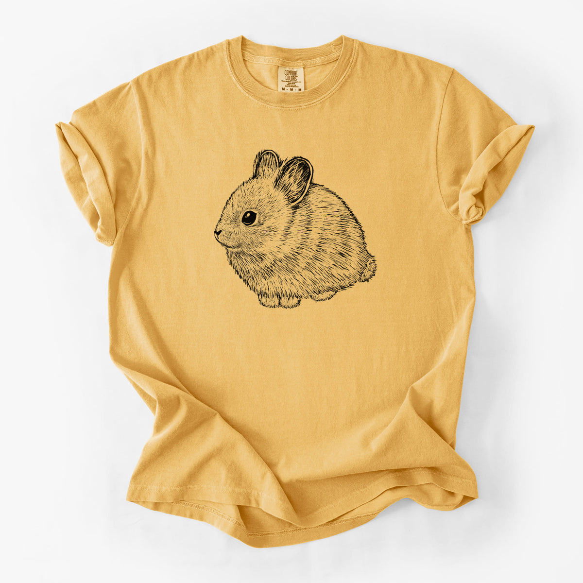 Golden wheat yellow Comfort Colors t-shirt laid flat, printed with a detailed black ink illustration of a round, fluffy pygmy rabbit.