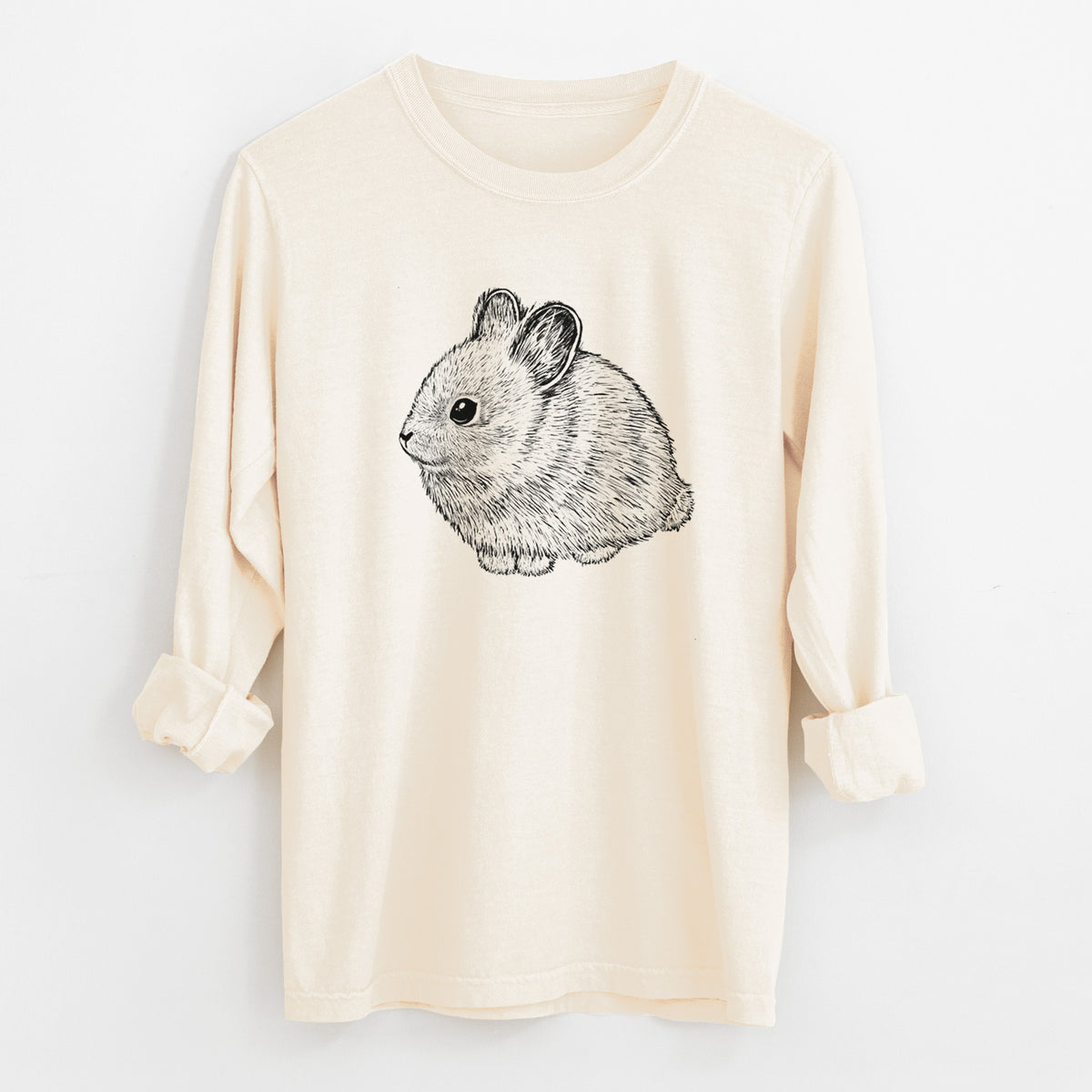 Ivory Comfort Colors long sleeve shirt laid flat with the cuffs rolled, printed with a detailed black ink illustration of a round, fluffy pygmy rabbit.