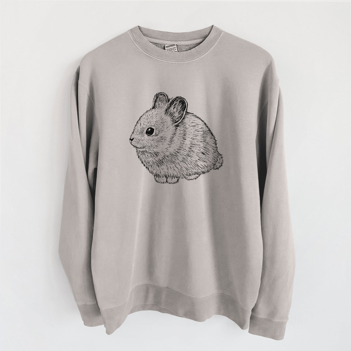 Cement grey pigment dyed crewneck sweatshirt laid flat, printed with a detailed black ink illustration of a round, fluffy pygmy rabbit.