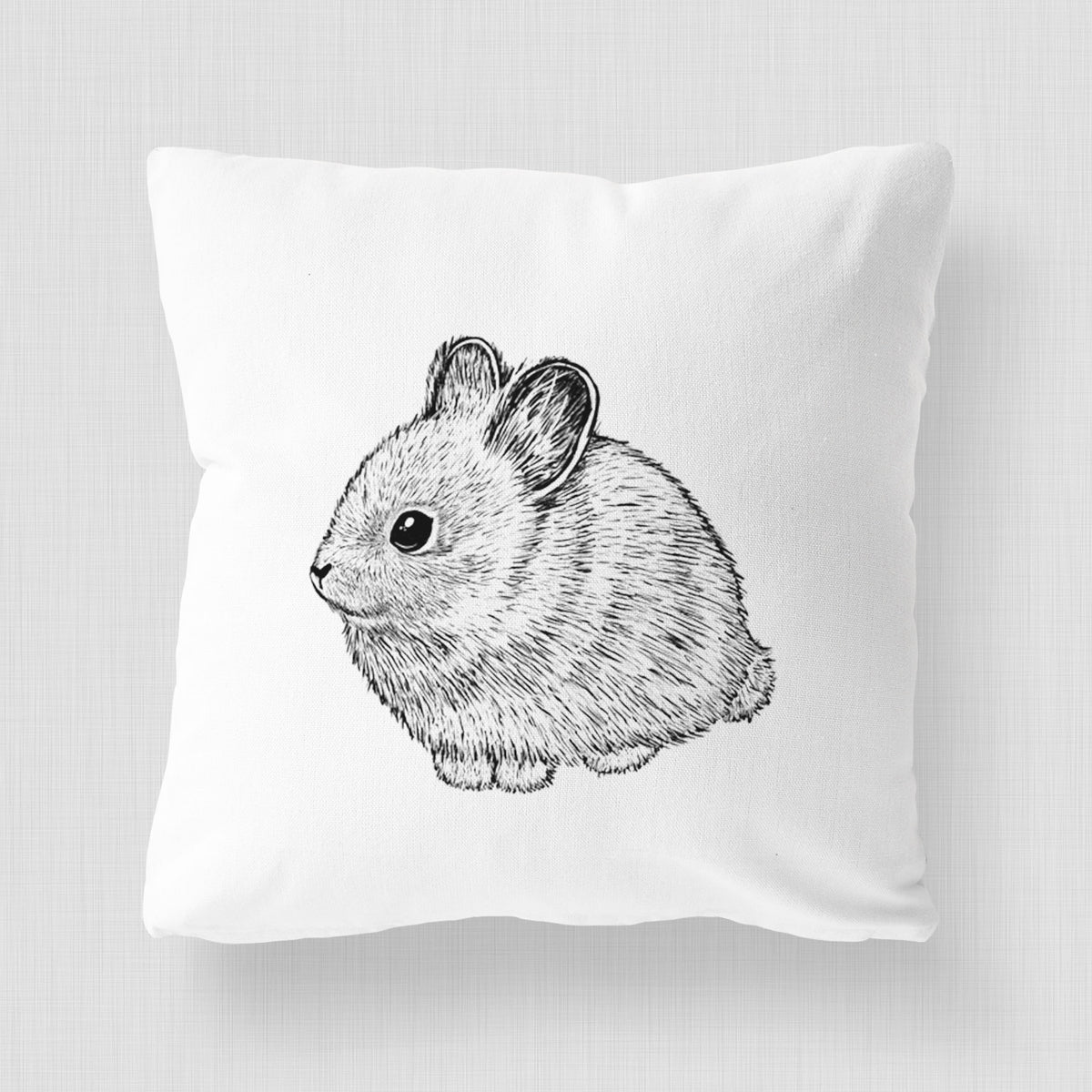 White pillow cover printed with a detailed black ink illustration of a round, fluffy pygmy rabbit.