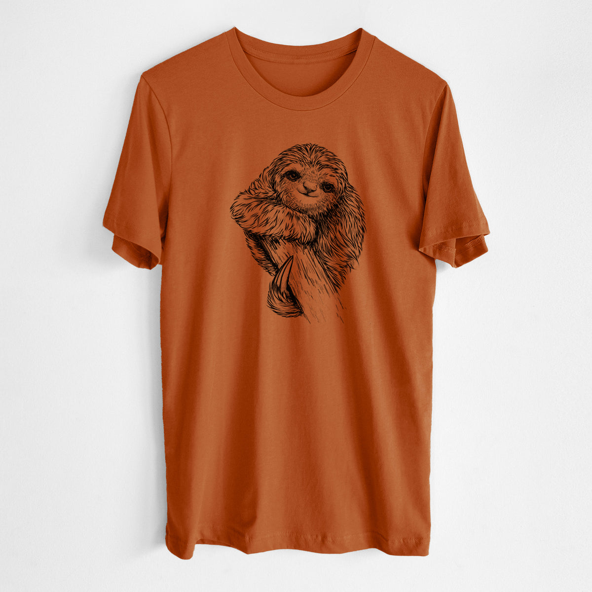 Autumn lightweight cotton t-shirt laid flat, printed with a detailed black ink illustration of a smiling pygmy three-toed sloth hanging from a branch.