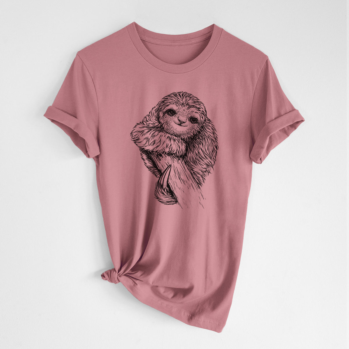 Mauve pink lightweight cotton t-shirt laid flat with the sleeves rolled, printed with a detailed black ink illustration of a smiling pygmy three-toed sloth hanging from a branch.