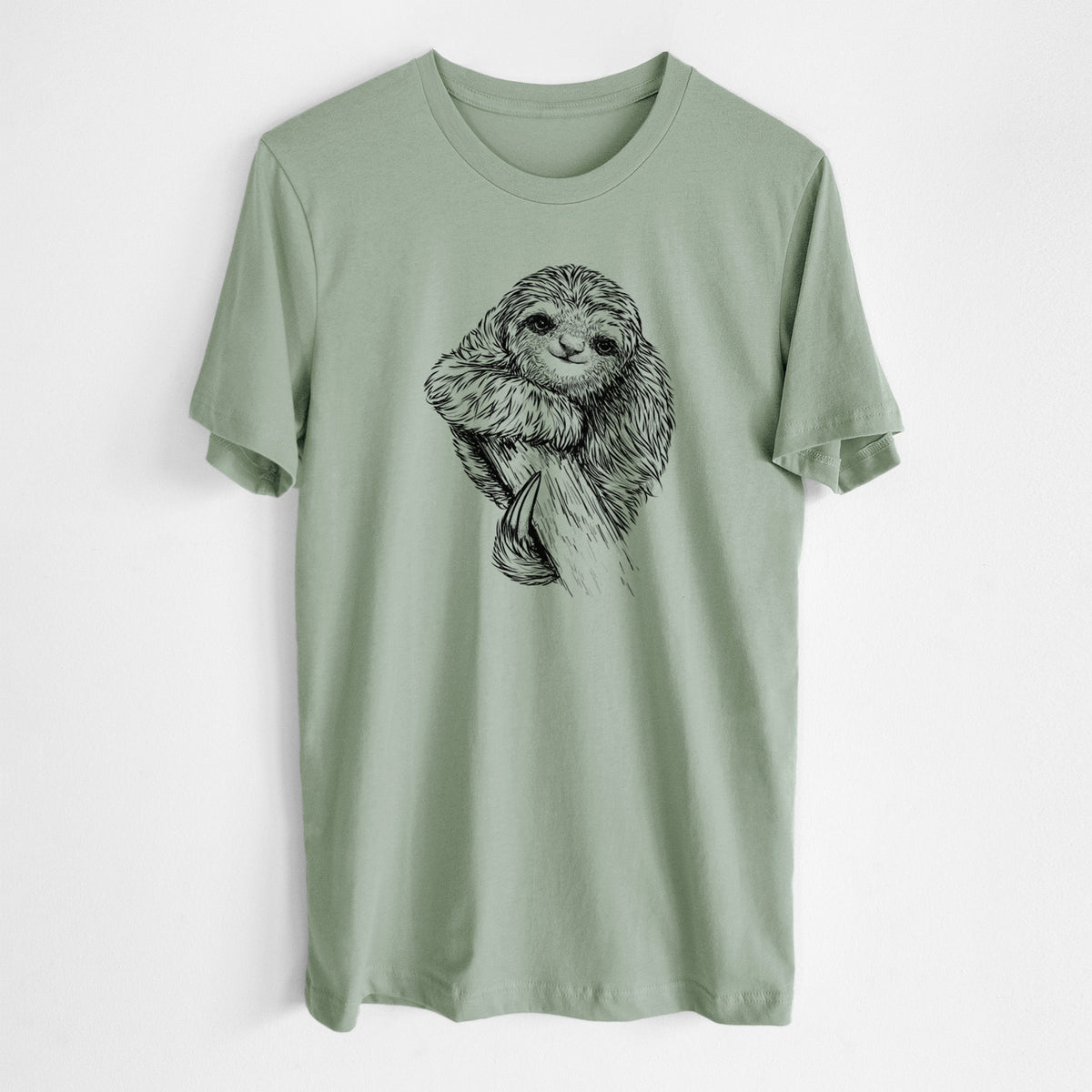 Sage green lightweight cotton t-shirt laid flat, printed with a detailed black ink illustration of a smiling pygmy three-toed sloth hanging from a branch.