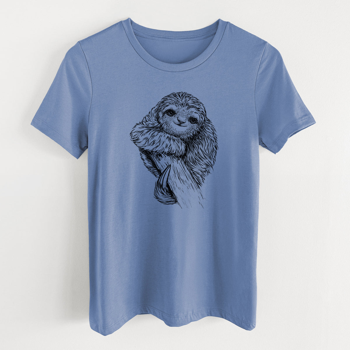 Blue bell women's relaxed fit cotton t-shirt laid flat, printed with a detailed black ink illustration of a smiling pygmy three-toed sloth hanging from a branch.