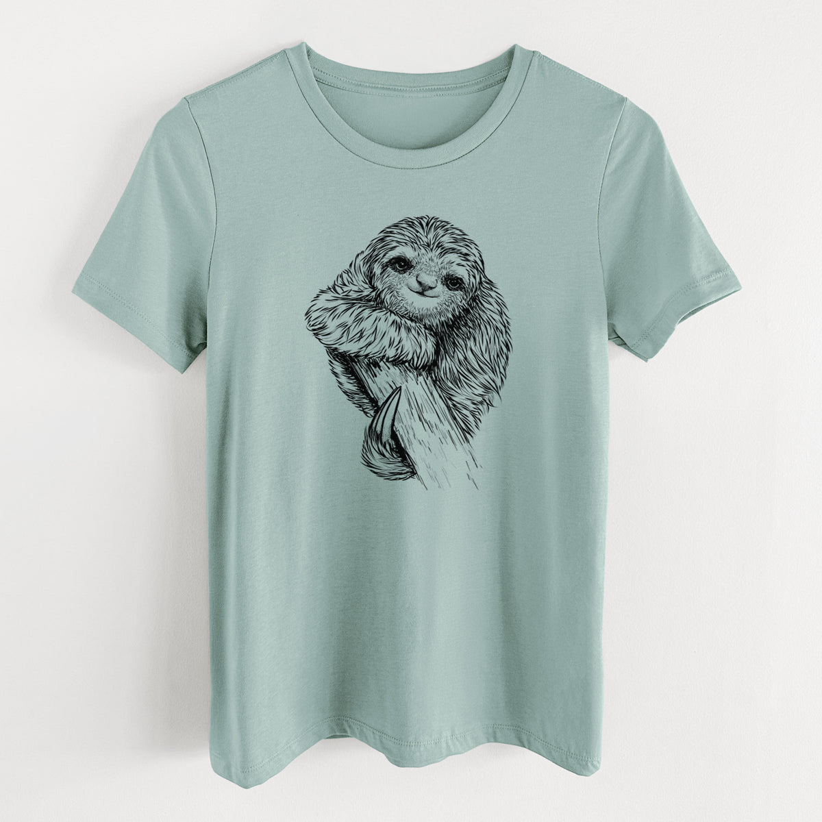 Dusty blue women's relaxed fit cotton t-shirt laid flat, printed with a detailed black ink illustration of a smiling pygmy three-toed sloth hanging from a branch.