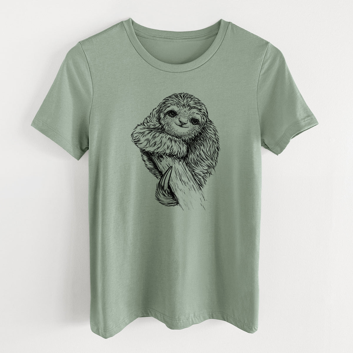 Sage green women's relaxed fit cotton t-shirt laid flat, printed with a detailed black ink illustration of a smiling pygmy three-toed sloth hanging from a branch.