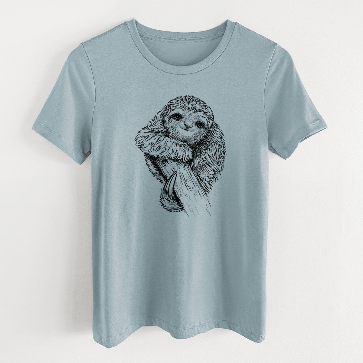 Vintage denim women's relaxed fit cotton t-shirt laid flat, printed with a detailed black ink illustration of a smiling pygmy three-toed sloth hanging from a branch.
