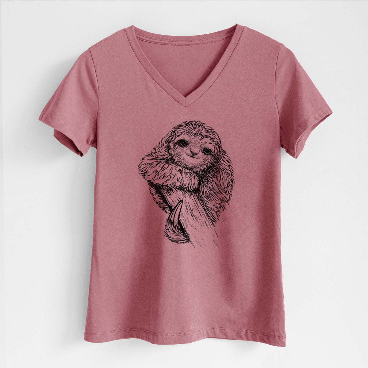 Mauve pink women's relaxed fit cotton V-neck t-shirt laid flat, printed with a detailed black ink illustration of a smiling pygmy three-toed sloth hanging from a branch.