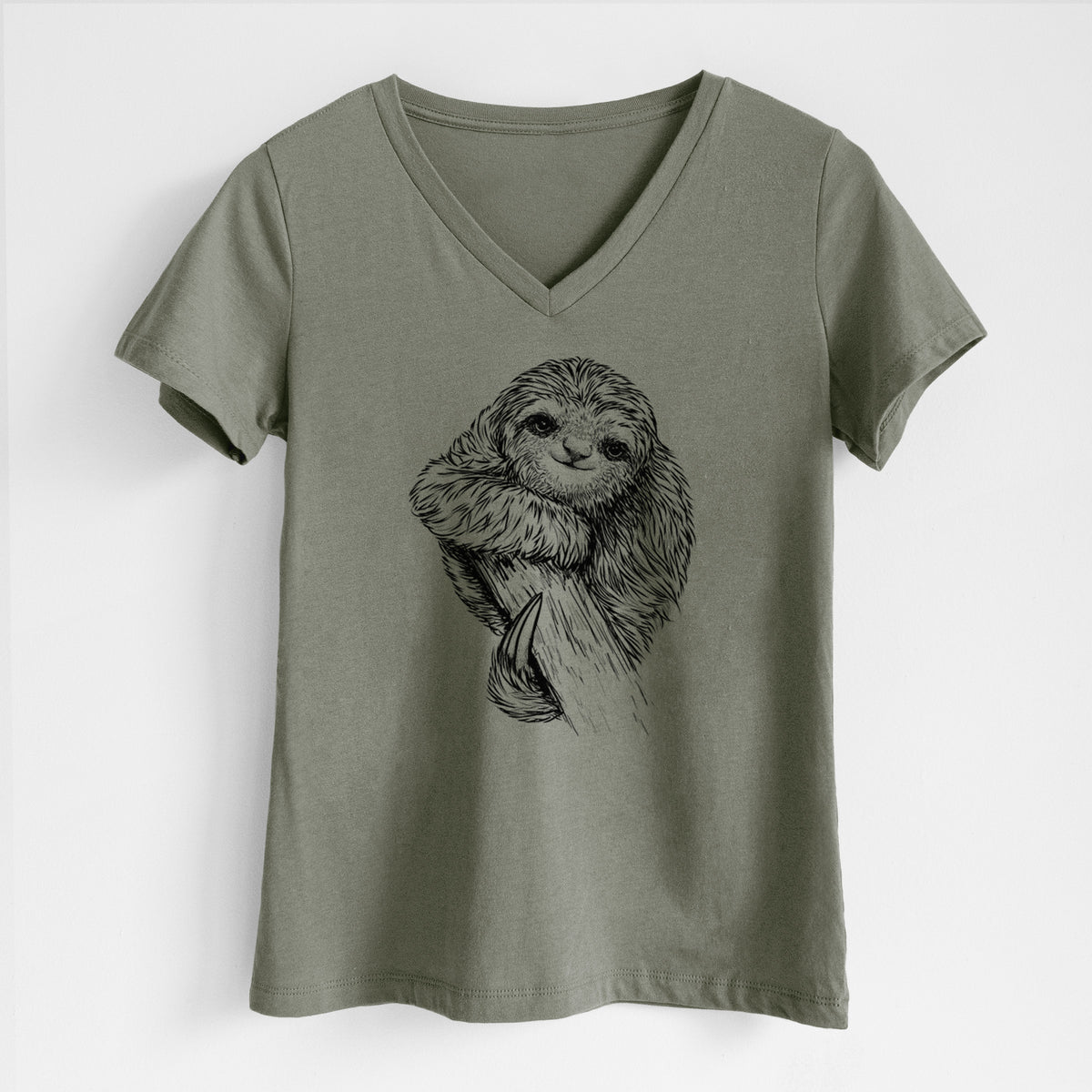 Military green women's relaxed fit cotton V-neck t-shirt laid flat, printed with a detailed black ink illustration of a smiling pygmy three-toed sloth hanging from a branch.