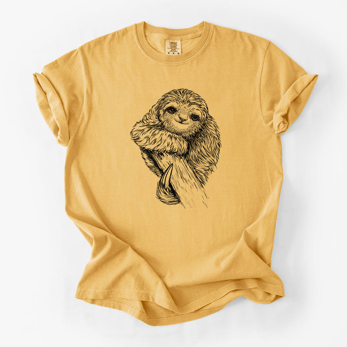 Golden wheat yellow Comfort Colors t-shirt laid flat, printed with a detailed black ink illustration of a smiling pygmy three-toed sloth hanging from a branch.