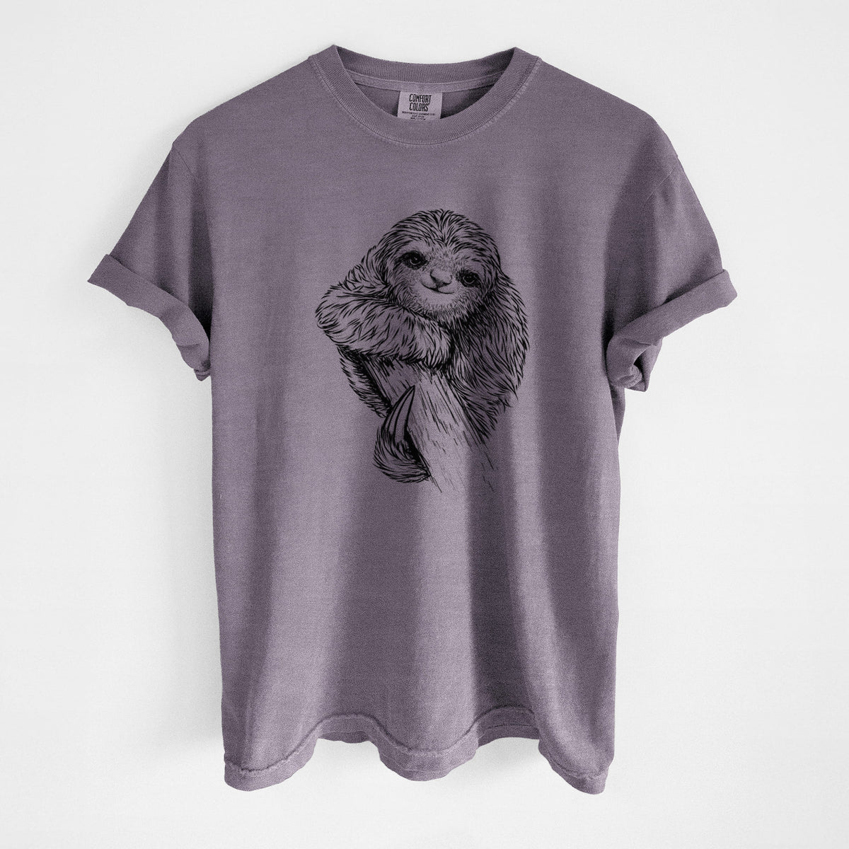 Wine red Comfort Colors t-shirt laid flat, printed with a detailed black ink illustration of a smiling pygmy three-toed sloth hanging from a branch.