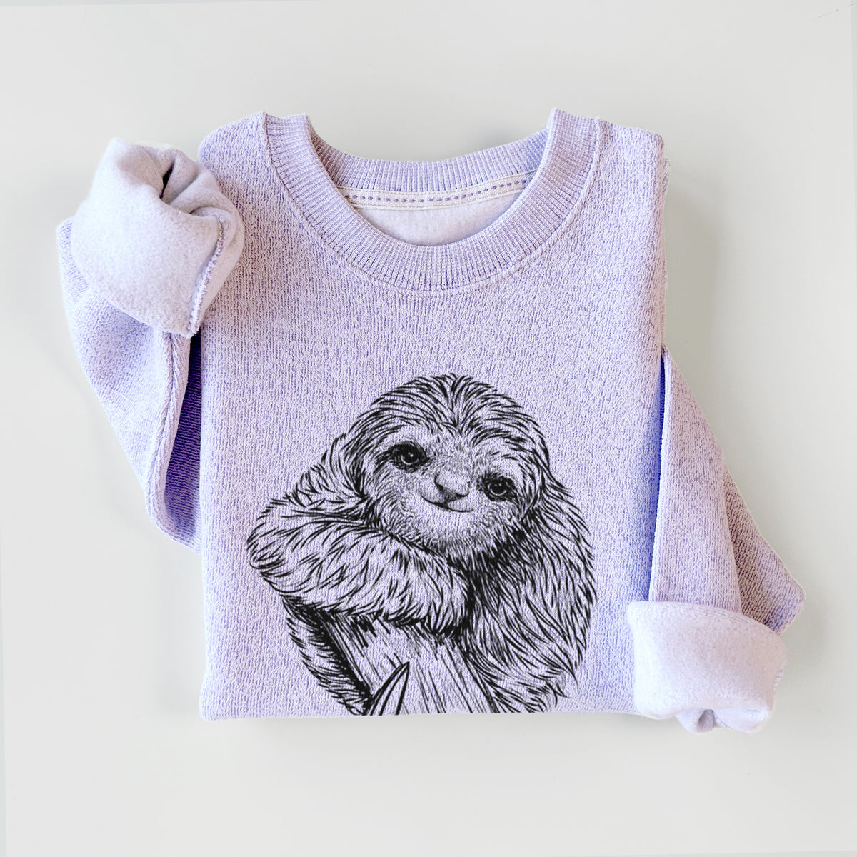 Ice purple knit sweatshirt printed with a detailed black ink illustration of a smiling pygmy three-toed sloth hanging from a branch, styled flat.