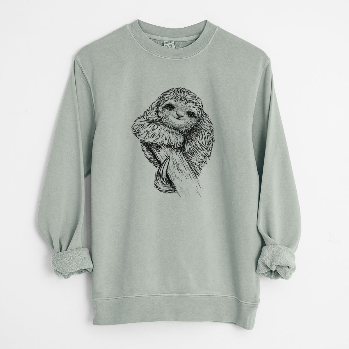 Sage green pigment dyed crewneck sweatshirt laid flat with the sleeves rolled, printed with a detailed black ink illustration of a smiling pygmy three-toed sloth hanging from a branch.