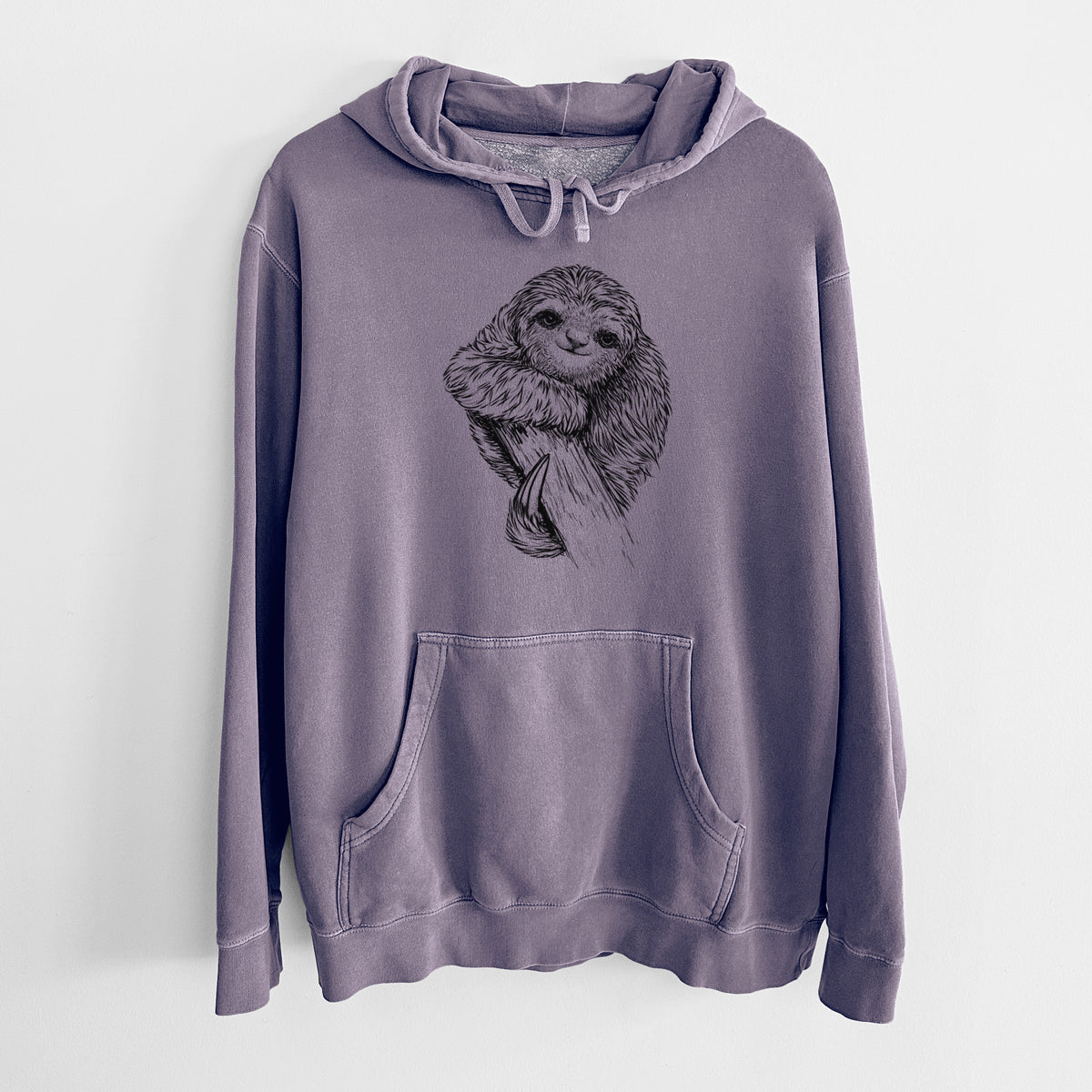Plum purple pigment dyed hoodie laid flat, printed with a detailed black ink illustration of a smiling pygmy three-toed sloth hanging from a branch.
