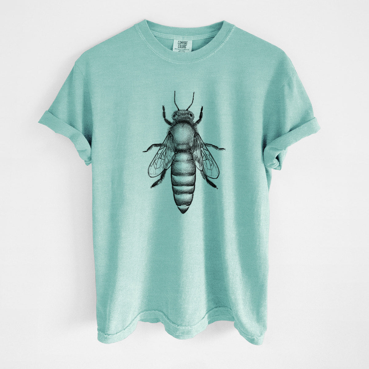 Chalky mint Comfort Colors t-shirt laid flat, printed with a detailed black ink illustration of a queen honey bee, seen from above.