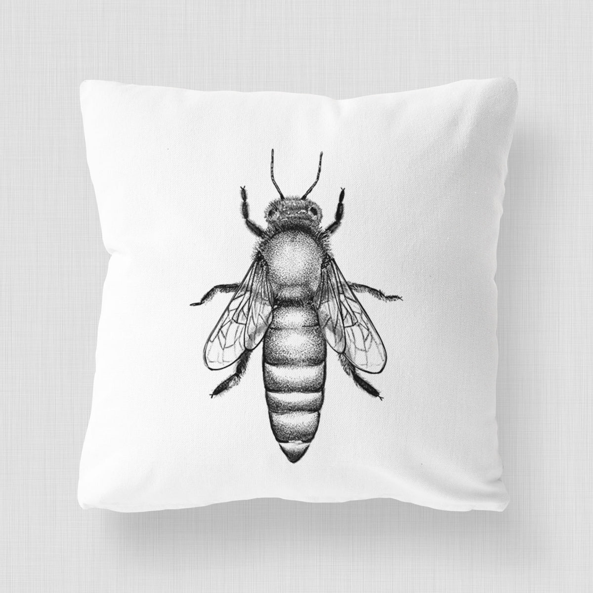 White pillow cover printed with a detailed black ink illustration of a queen honey bee, seen from above.