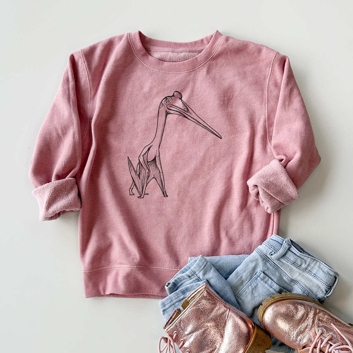 Youth crewneck sweatshirt printed with a black ink illustration of a Quetzalcoatlus pterosaur standing on all fours, styled flat with jeans and boots.