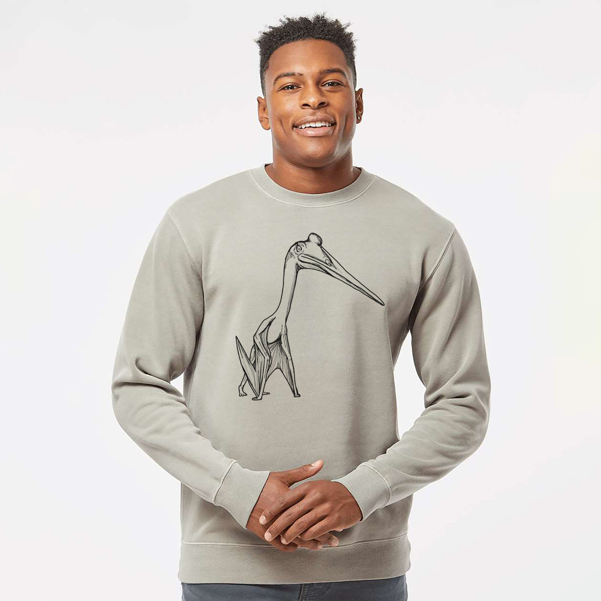 Model wearing a cement grey pigment dyed crewneck sweatshirt printed with a black ink illustration of a Quetzalcoatlus pterosaur standing on all fours.