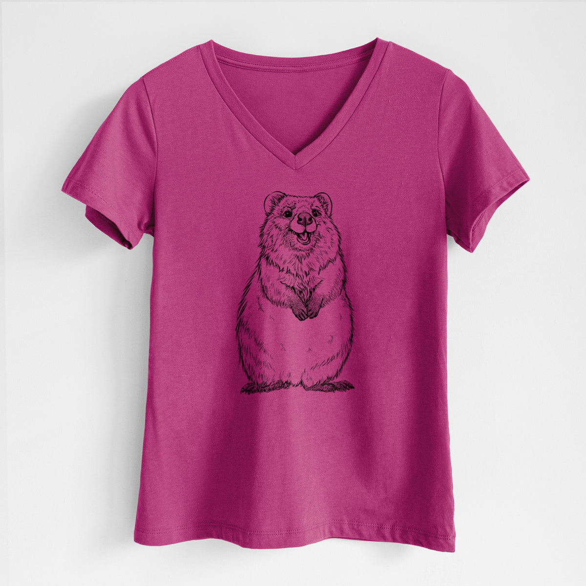 Berry pink women's relaxed fit cotton V-neck t-shirt laid flat, printed with a black ink illustration of a smiling quokka sitting upright.
