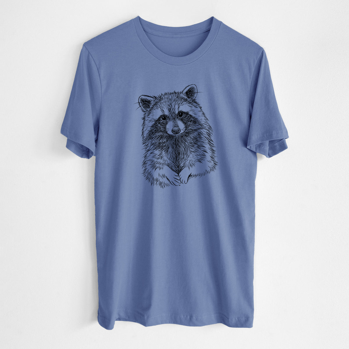 Blue bell lightweight cotton t-shirt laid flat, printed with a detailed black ink portrait of a raccoon with its front paws resting in front of it.