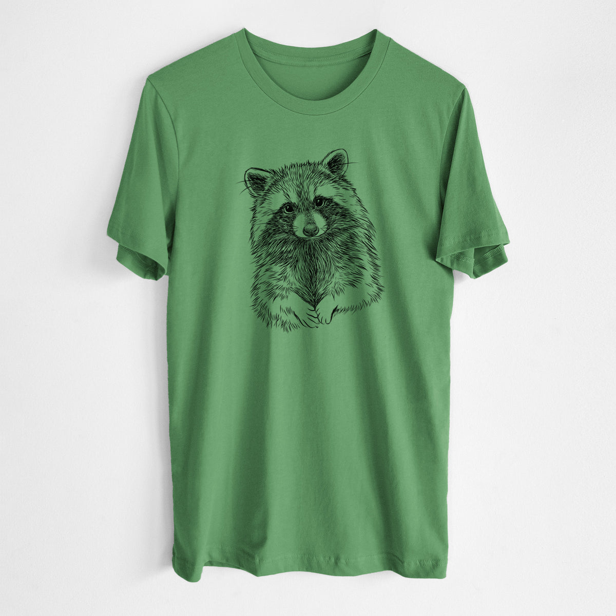 Leaf green lightweight cotton t-shirt laid flat, printed with a detailed black ink portrait of a raccoon with its front paws resting in front of it.