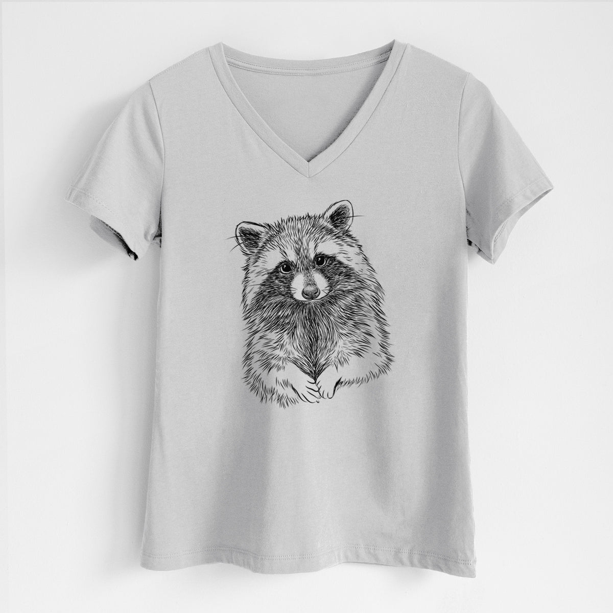 Lunar grey women's relaxed fit cotton V-neck t-shirt laid flat, printed with a detailed black ink portrait of a raccoon with its front paws resting in front of it.