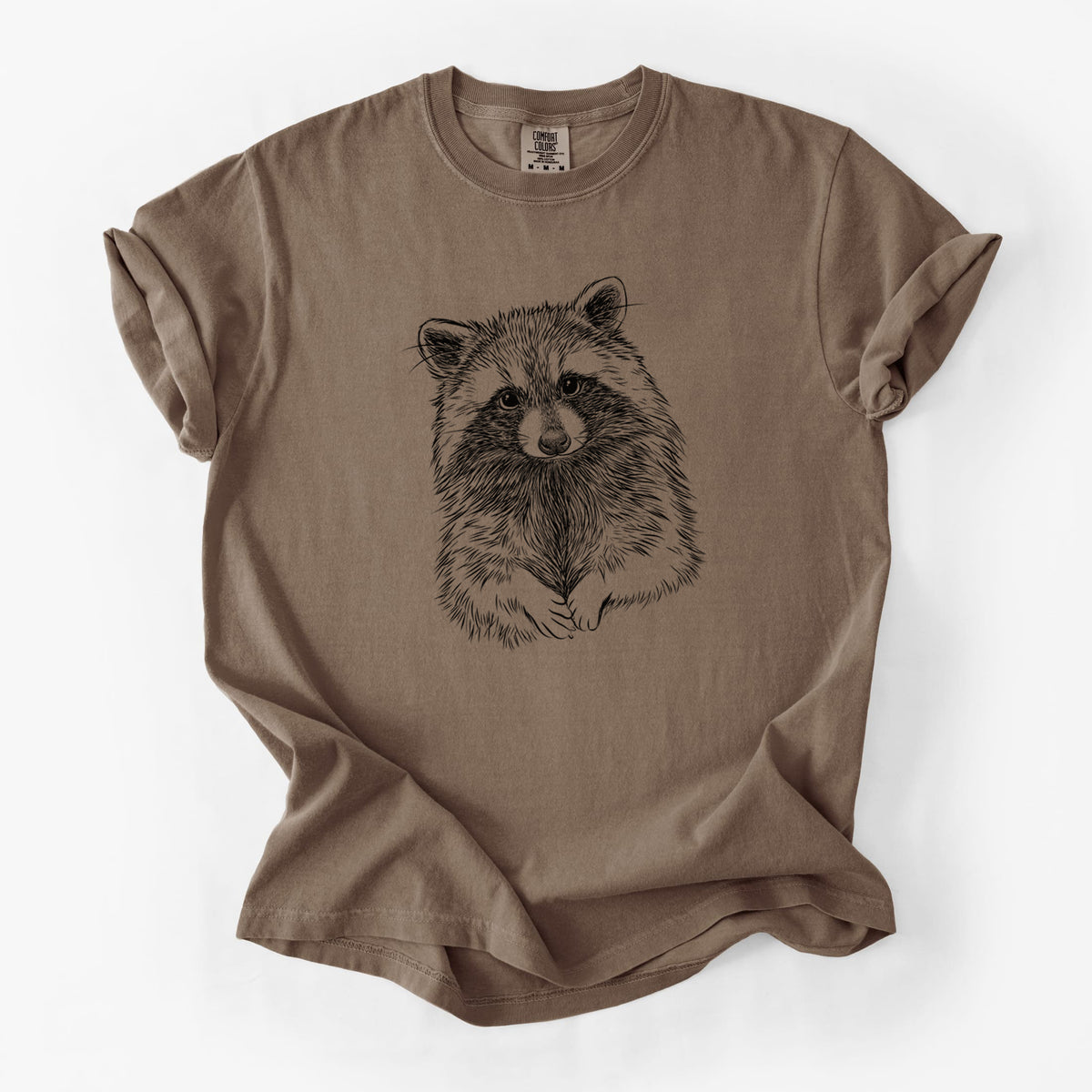 Espresso brown Comfort Colors t-shirt laid flat, printed with a detailed black ink portrait of a raccoon with its front paws resting in front of it.
