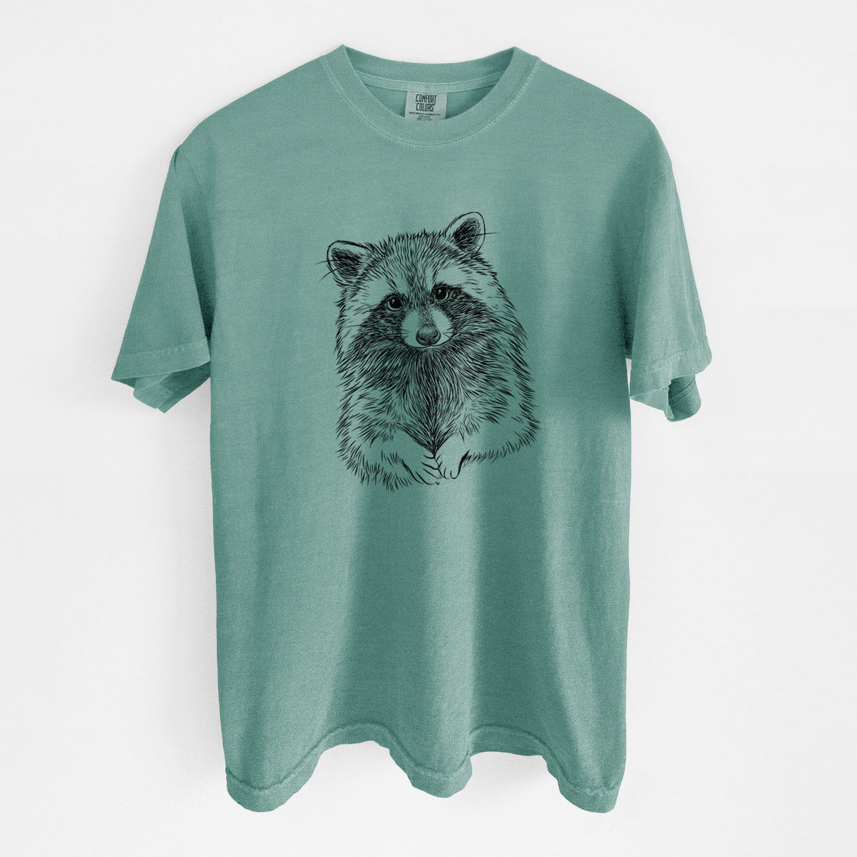 Reef green Comfort Colors t-shirt laid flat, printed with a detailed black ink portrait of a raccoon with its front paws resting in front of it.