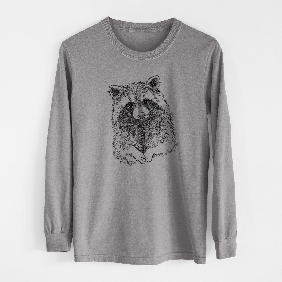 Grey Comfort Colors long sleeve shirt laid flat, printed with a detailed black ink portrait of a raccoon with its front paws resting in front of it.