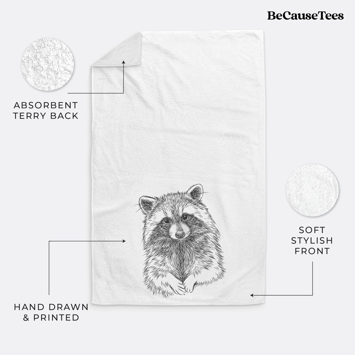 White hand towel printed with a detailed black ink portrait of a raccoon with its front paws resting in front of it.