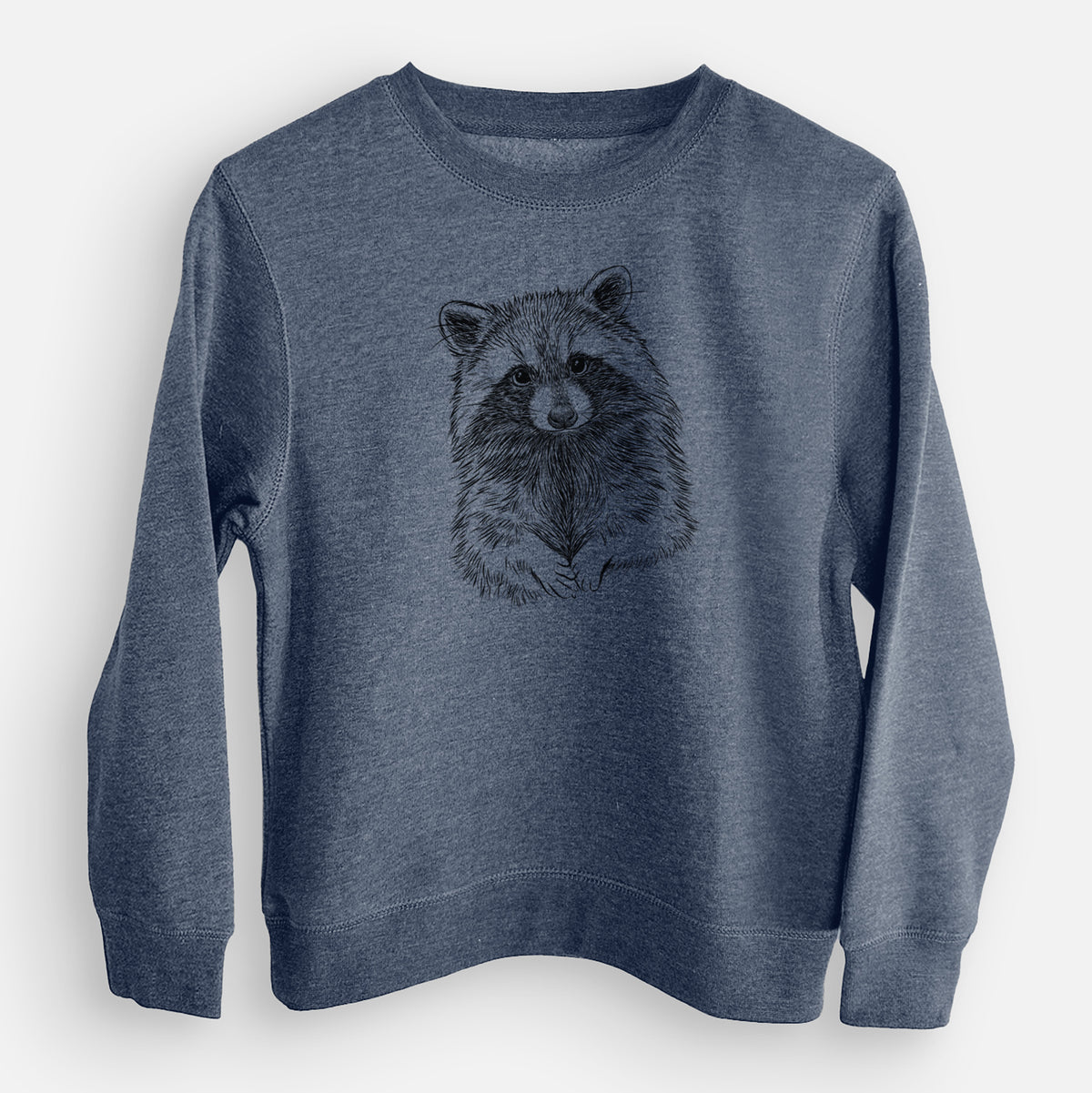 Storm blue youth crewneck sweatshirt laid flat, printed with a detailed black ink portrait of a raccoon with its front paws resting in front of it.