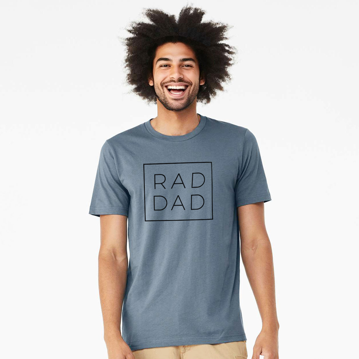 Vintage denim lightweight cotton t-shirt laid flat, printed with the words RAD DAD in thin black letters stacked inside a square outline.