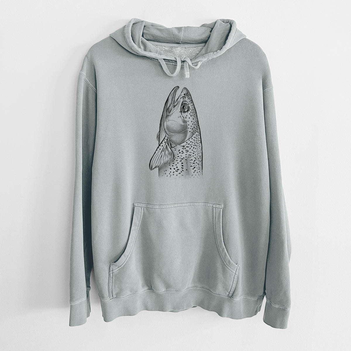 Sage green pigment dyed hoodie laid flat, printed with a detailed black ink illustration of a rainbow trout's head pointing upward, showing its spotted scales.