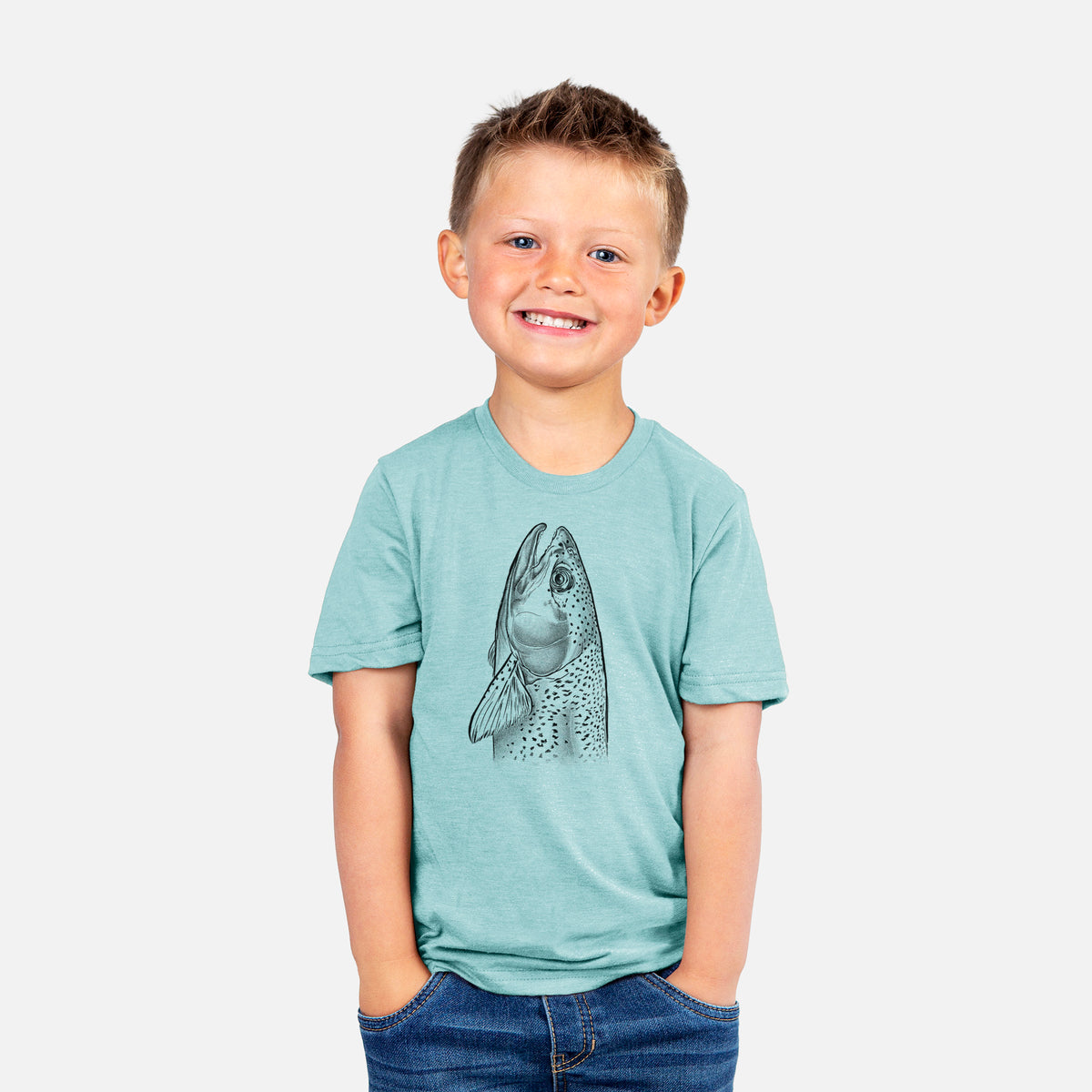 Smiling boy wearing a youth t-shirt printed with a detailed black ink illustration of a rainbow trout's head pointing upward, showing its spotted scales.