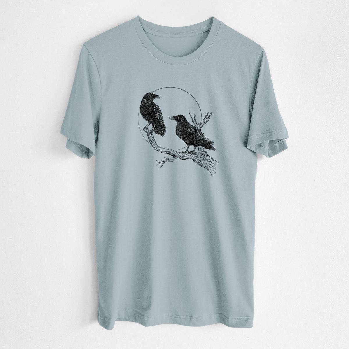 Vintage denim lightweight cotton t-shirt laid flat, printed with a black ink illustration of two ravens perched on a branch in front of a full moon.