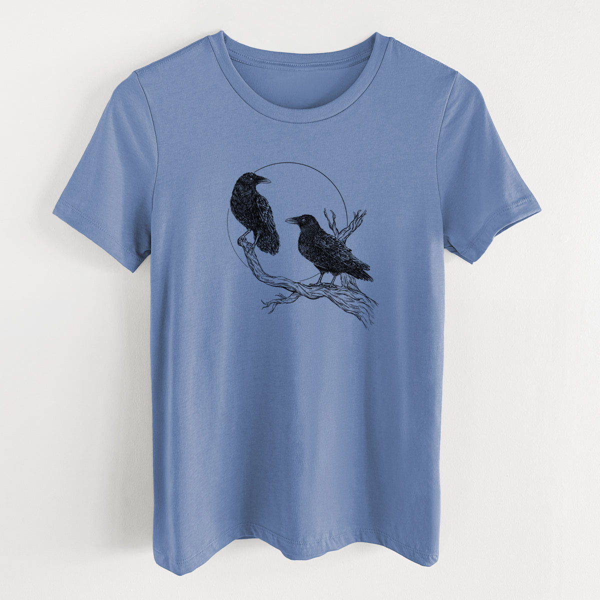 Blue bell women's relaxed fit cotton t-shirt laid flat, printed with a black ink illustration of two ravens perched on a branch in front of a full moon.