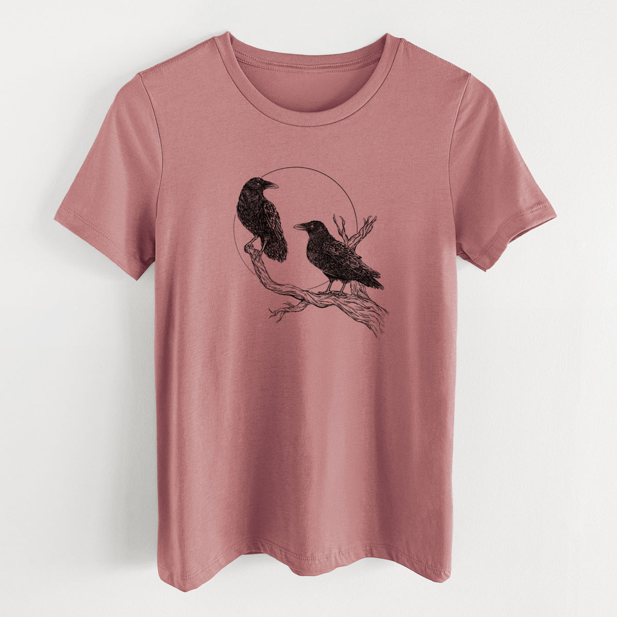 Mauve pink women's relaxed fit cotton t-shirt laid flat, printed with a black ink illustration of two ravens perched on a branch in front of a full moon.