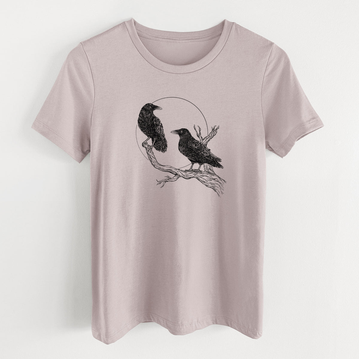 Pink gravel women's relaxed fit cotton t-shirt laid flat, printed with a black ink illustration of two ravens perched on a branch in front of a full moon.