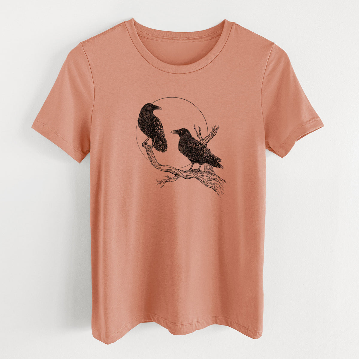 Terracotta orange women's relaxed fit cotton t-shirt laid flat, printed with a black ink illustration of two ravens perched on a branch in front of a full moon.