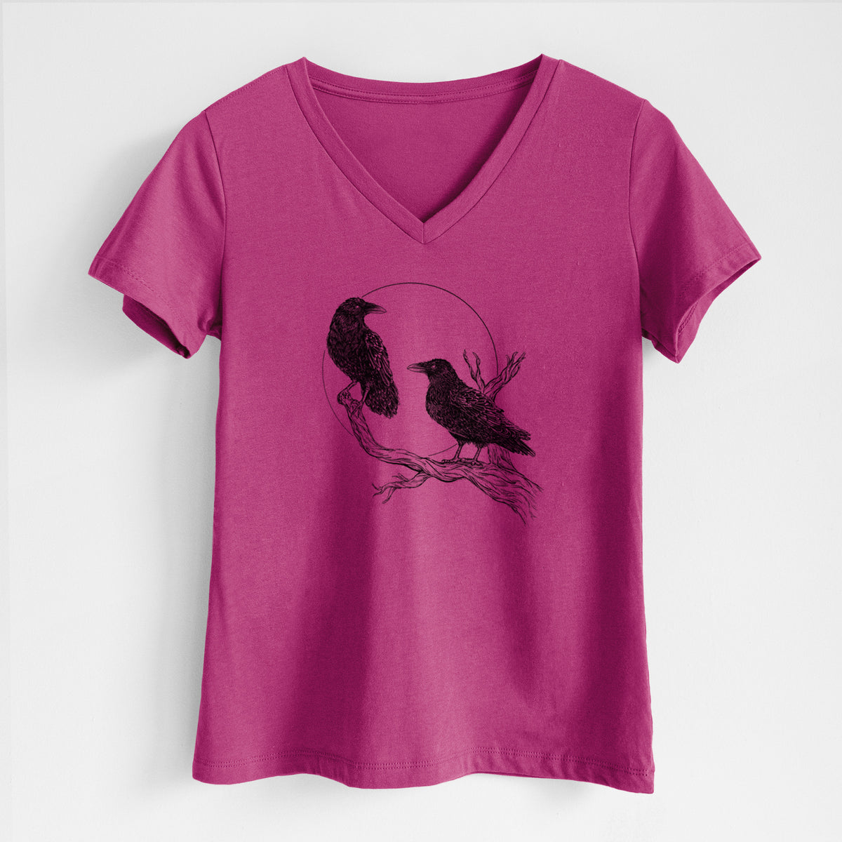 Berry pink women's relaxed fit cotton V-neck t-shirt laid flat, printed with a black ink illustration of two ravens perched on a branch in front of a full moon.