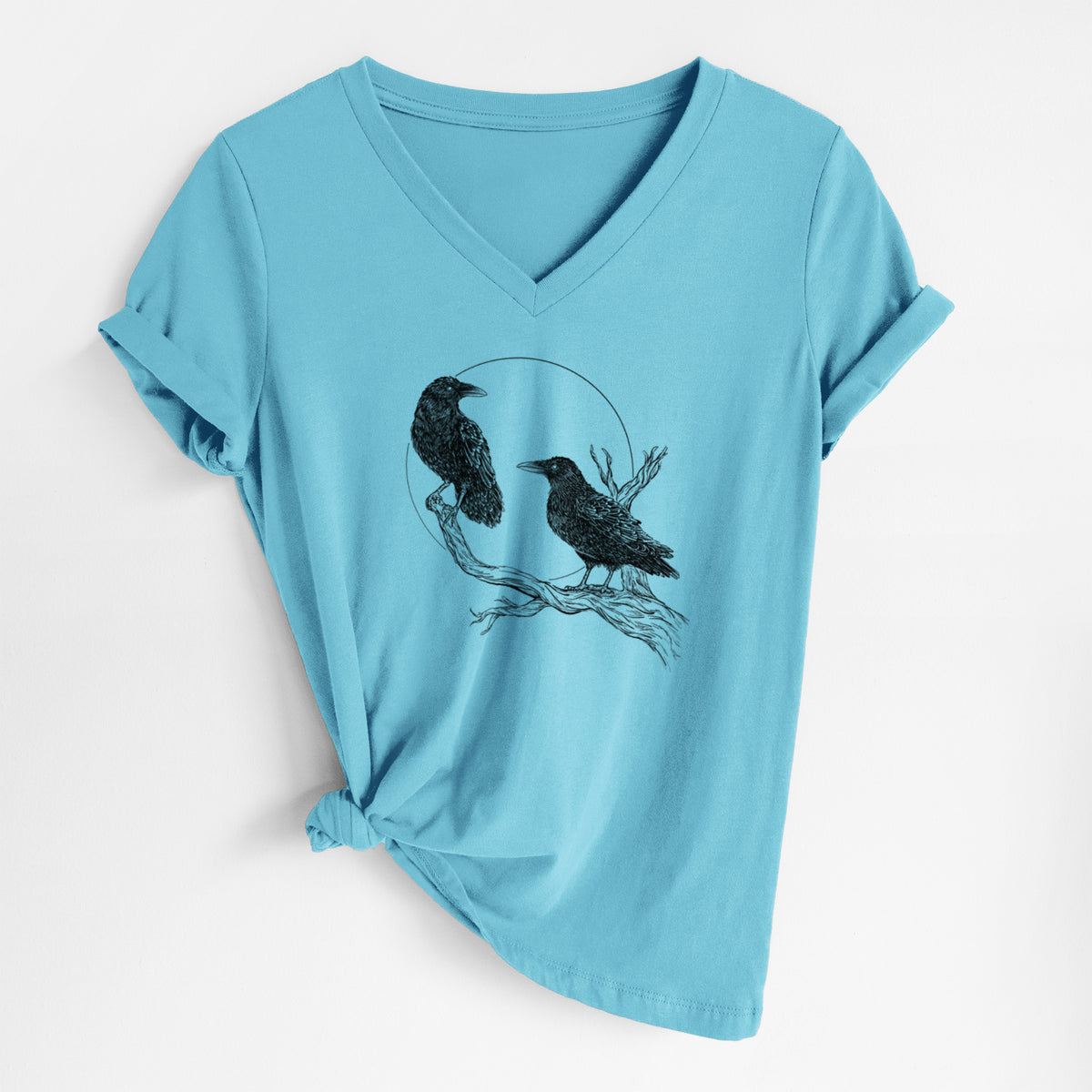 Turquoise women's relaxed fit cotton V-neck t-shirt laid flat, printed with a black ink illustration of two ravens perched on a branch in front of a full moon.