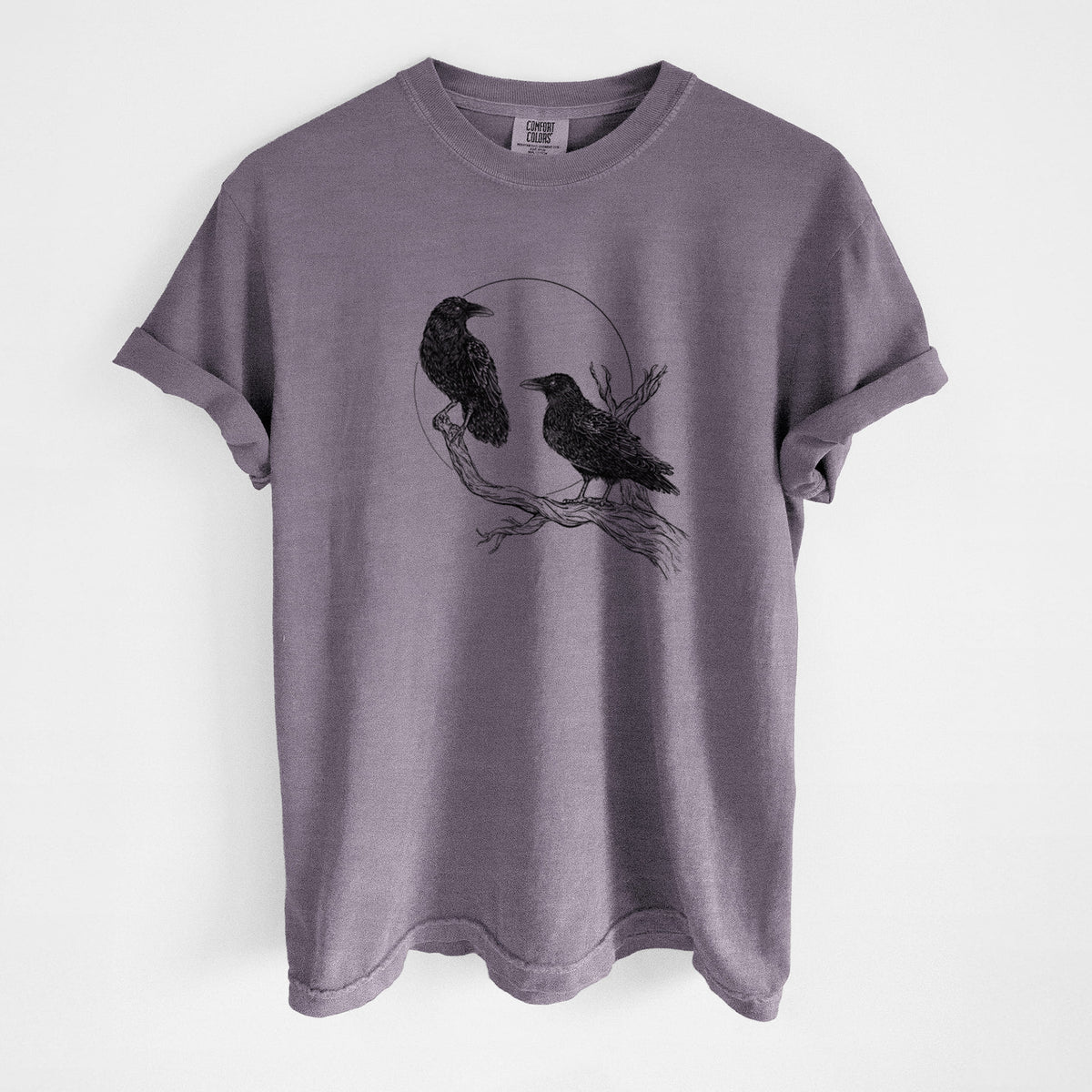 Wine red Comfort Colors t-shirt laid flat, printed with a black ink illustration of two ravens perched on a branch in front of a full moon.