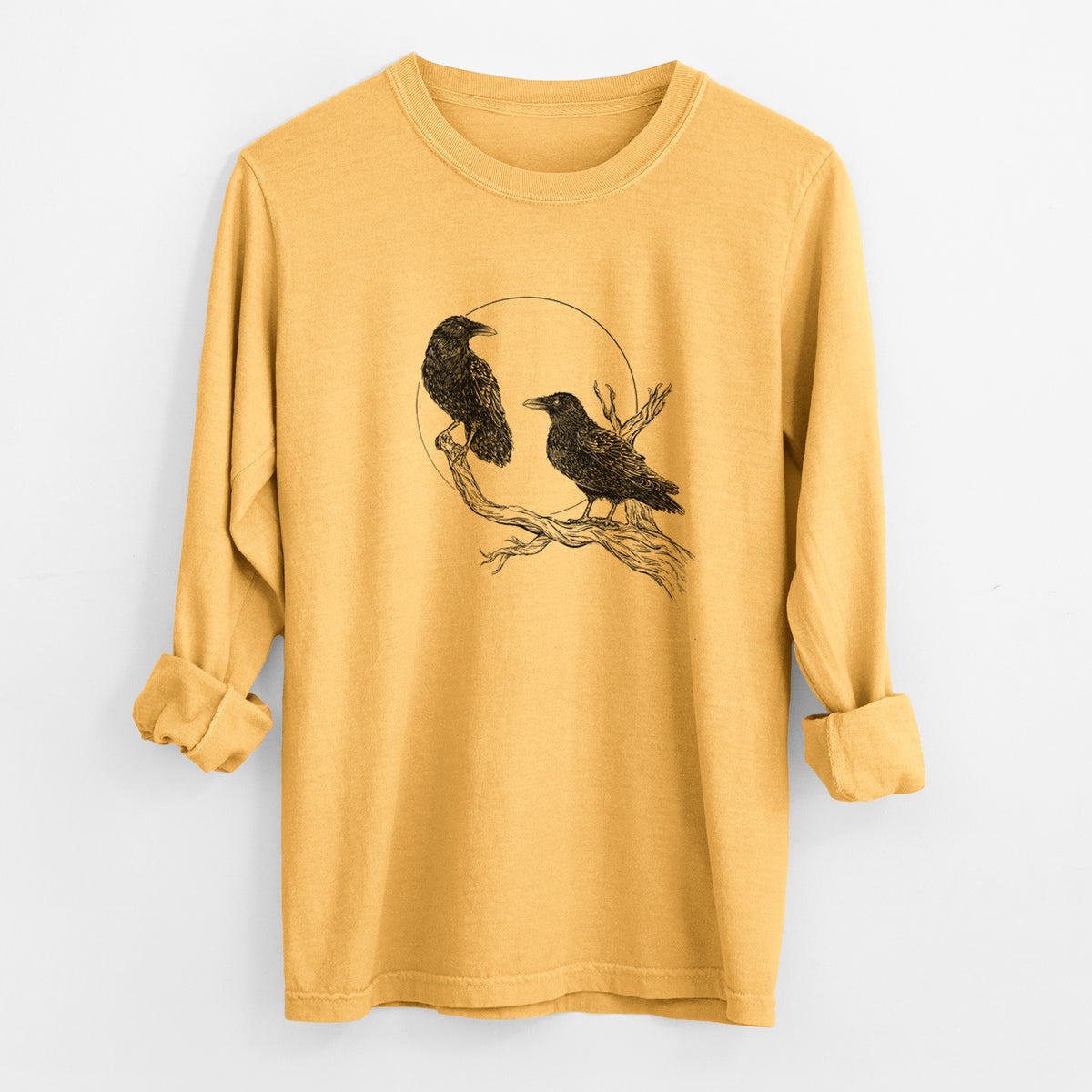 Golden wheat yellow Comfort Colors long sleeve shirt laid flat with the cuffs rolled, printed with a black ink illustration of two ravens perched on a branch in front of a full moon.