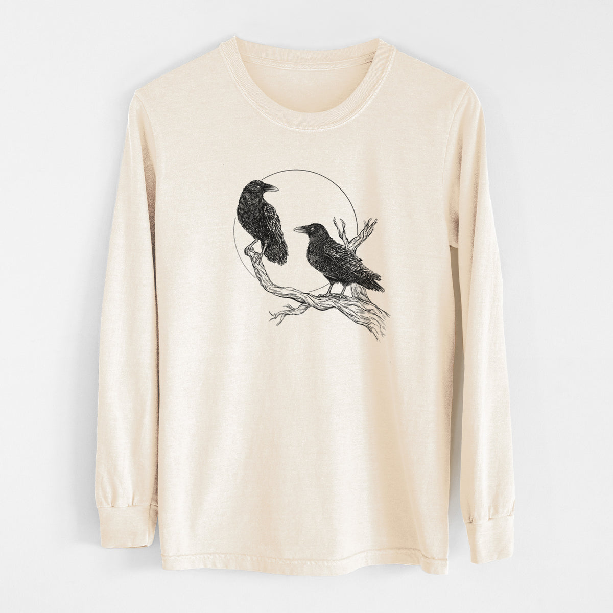 Ivory Comfort Colors long sleeve shirt laid flat, printed with a black ink illustration of two ravens perched on a branch in front of a full moon.