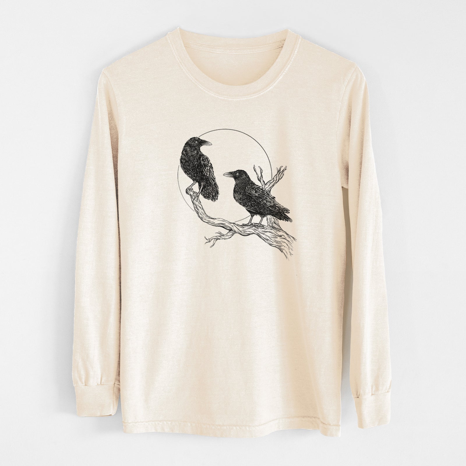 Ivory Comfort Colors long sleeve shirt laid flat, printed with a black ink illustration of two ravens perched on a branch in front of a full moon.